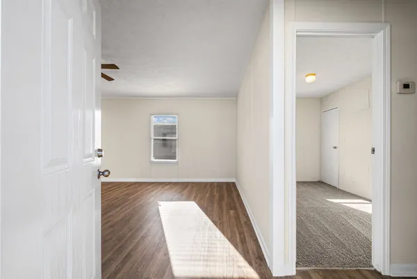 a view of a kitchen with wooden floor and a ceiling fan