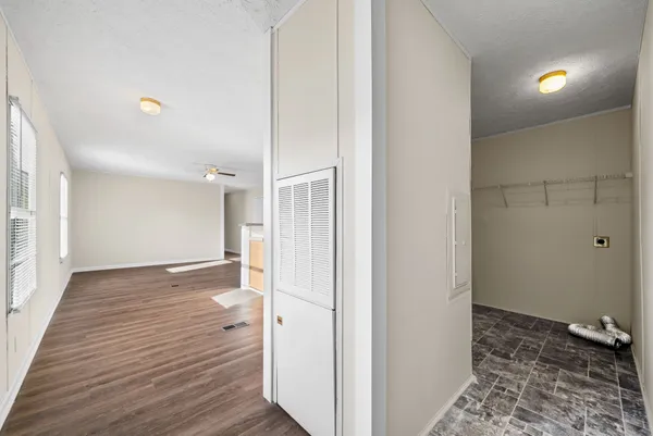 a view of an empty room with a ceiling fan