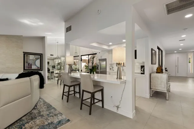 a spacious bedroom with a large bed and a flat screen tv