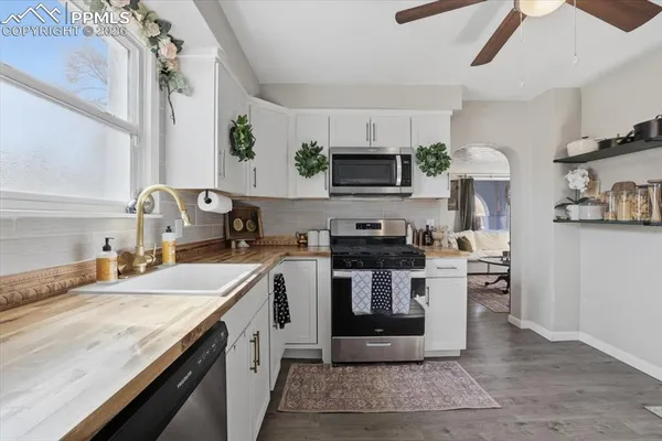 a kitchen with stainless steel appliances granite countertop a sink stove microwave and cabinets