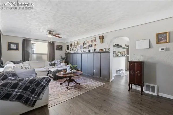 a living room with furniture and wooden floor