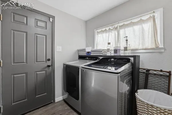 a view of a utility room with granite countertop cabinets and a sink