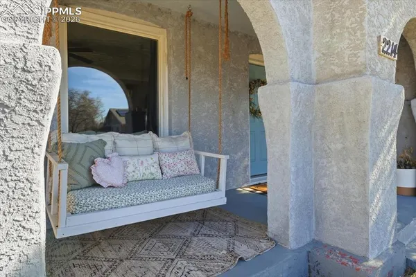 a living room with a couch and a potted plant