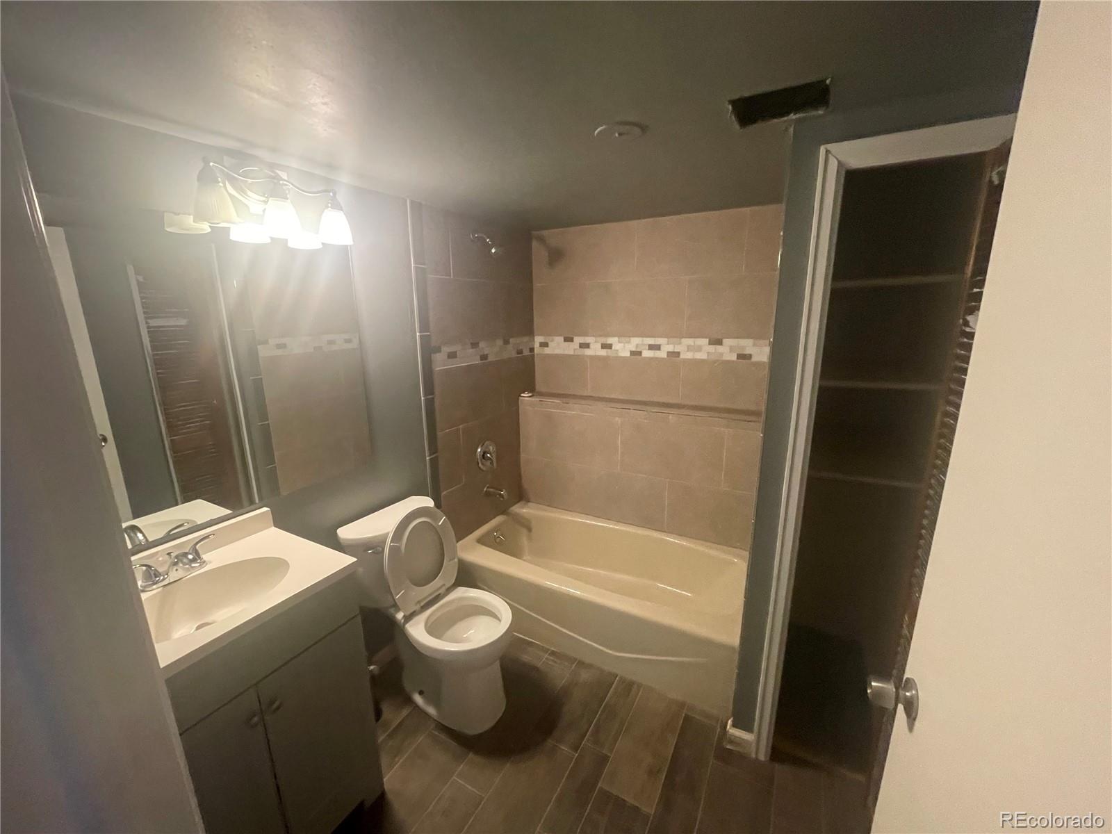 3817 South Ceylon Way Aurora, CO 80013 - Photo 12 of 18 a bathroom with a sink toilet and shower