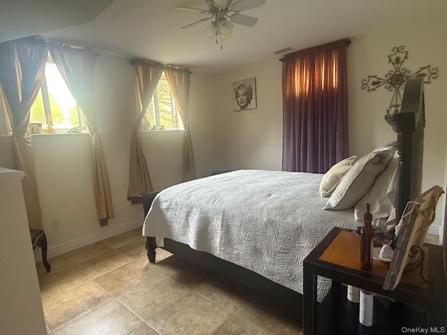 4225 Stars Road East Marion, NY 11939 - Photo 8 of 16 a bedroom with a bed and a chandelier