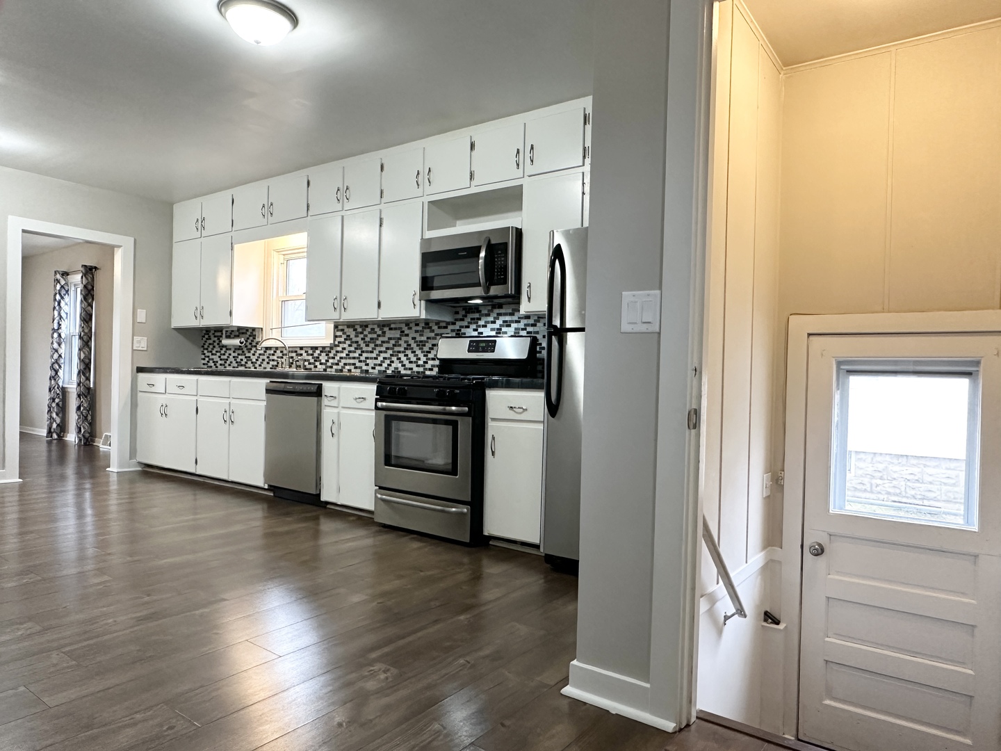 1075 South 7th Avenue Kankakee, IL 60901 - Photo 11 of 32 a kitchen with stainless steel appliances granite countertop a stove and a refrigerator