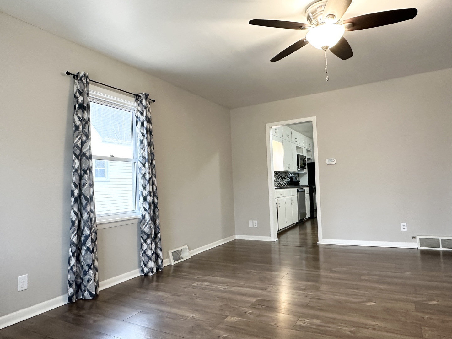 1075 South 7th Avenue Kankakee, IL 60901 - Photo 5 of 32 a view of empty room with wooden floor and fan
