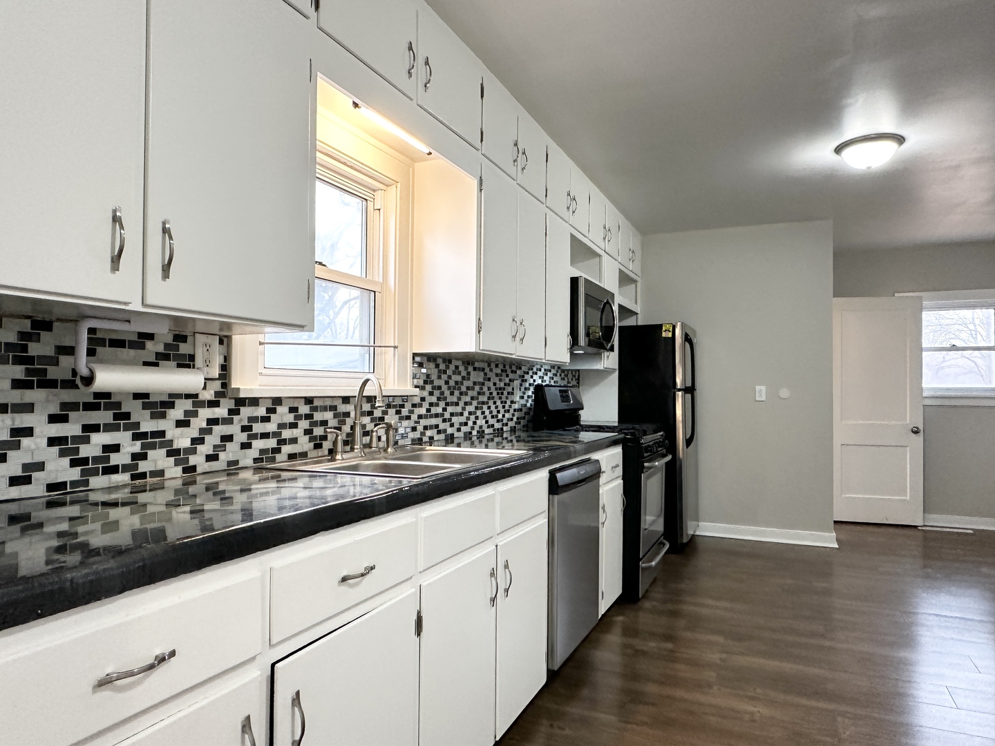 1075 South 7th Avenue Kankakee, IL 60901 - Photo 7 of 32 a kitchen with stainless steel appliances kitchen island granite countertop a stove a sink and a refrigerator