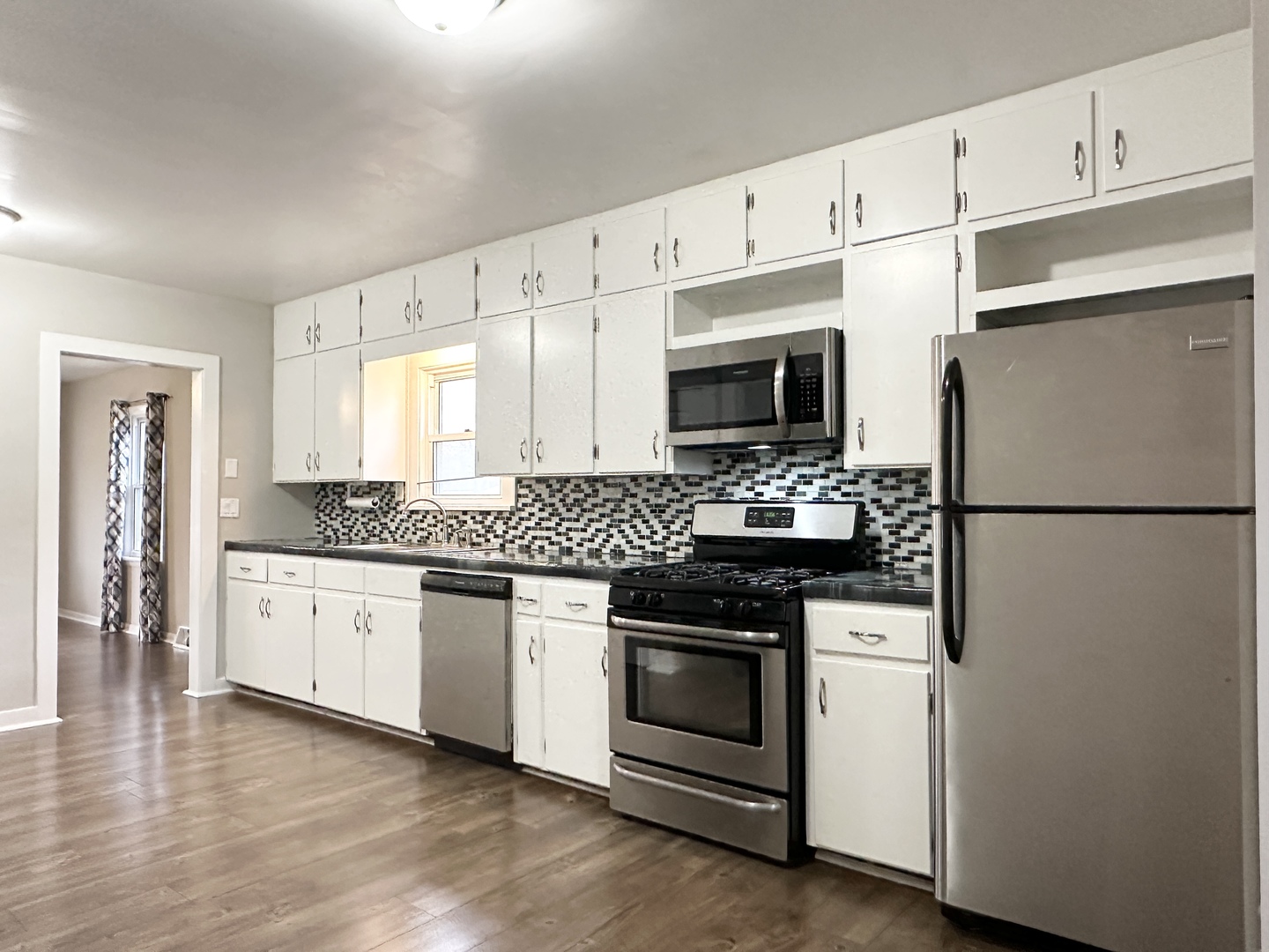 1075 South 7th Avenue Kankakee, IL 60901 - Photo 10 of 32 a kitchen with granite countertop white cabinets and stainless steel appliances