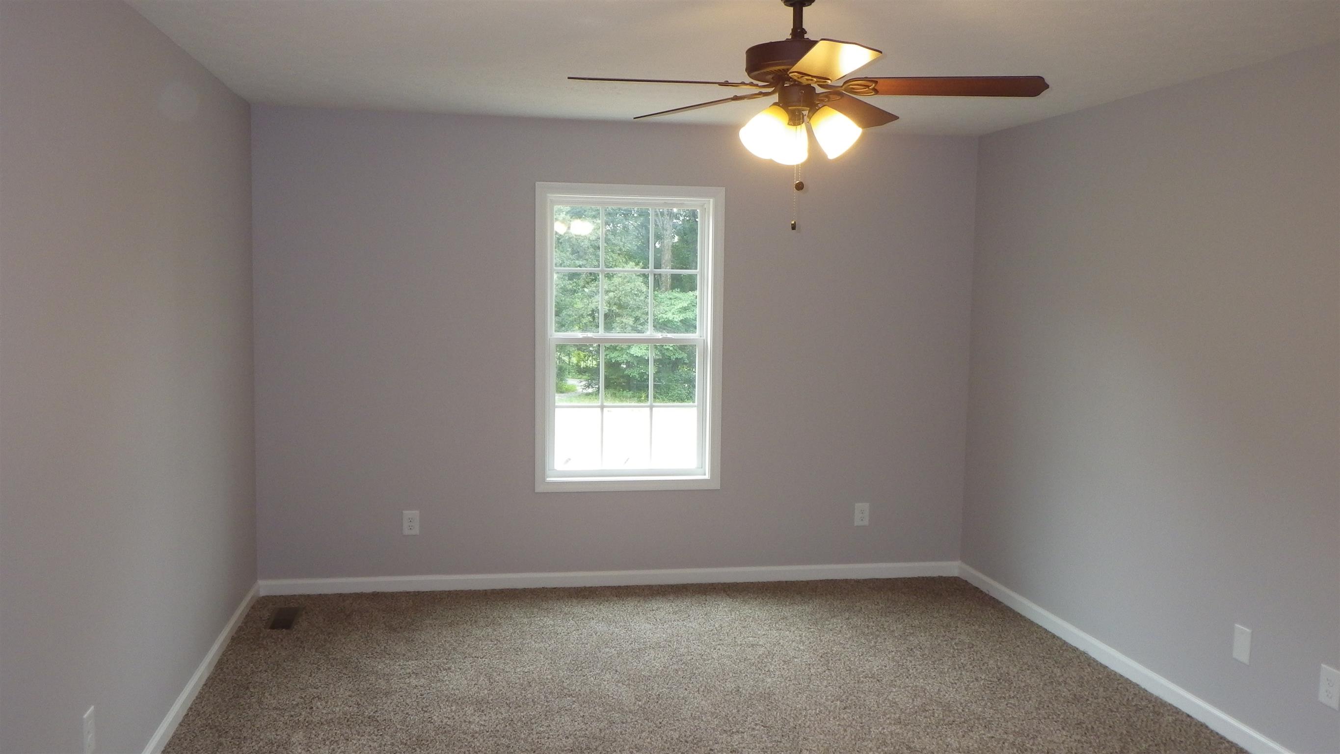1211 East Ab Wade Road Portland, TN 37148 - Photo 14 of 30 an empty room with windows and fan