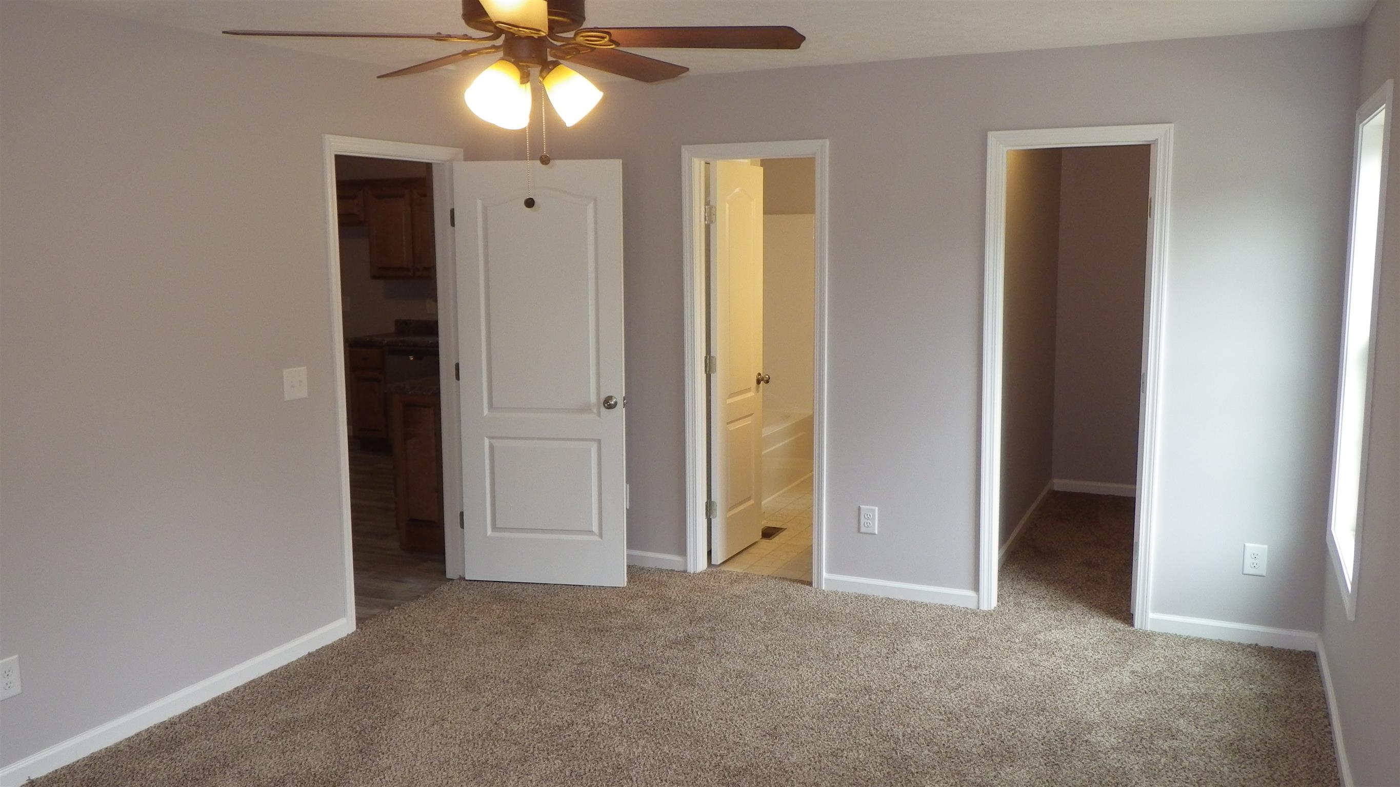 1211 East Ab Wade Road Portland, TN 37148 - Photo 16 of 30 an empty room with closet and a chandelier fan