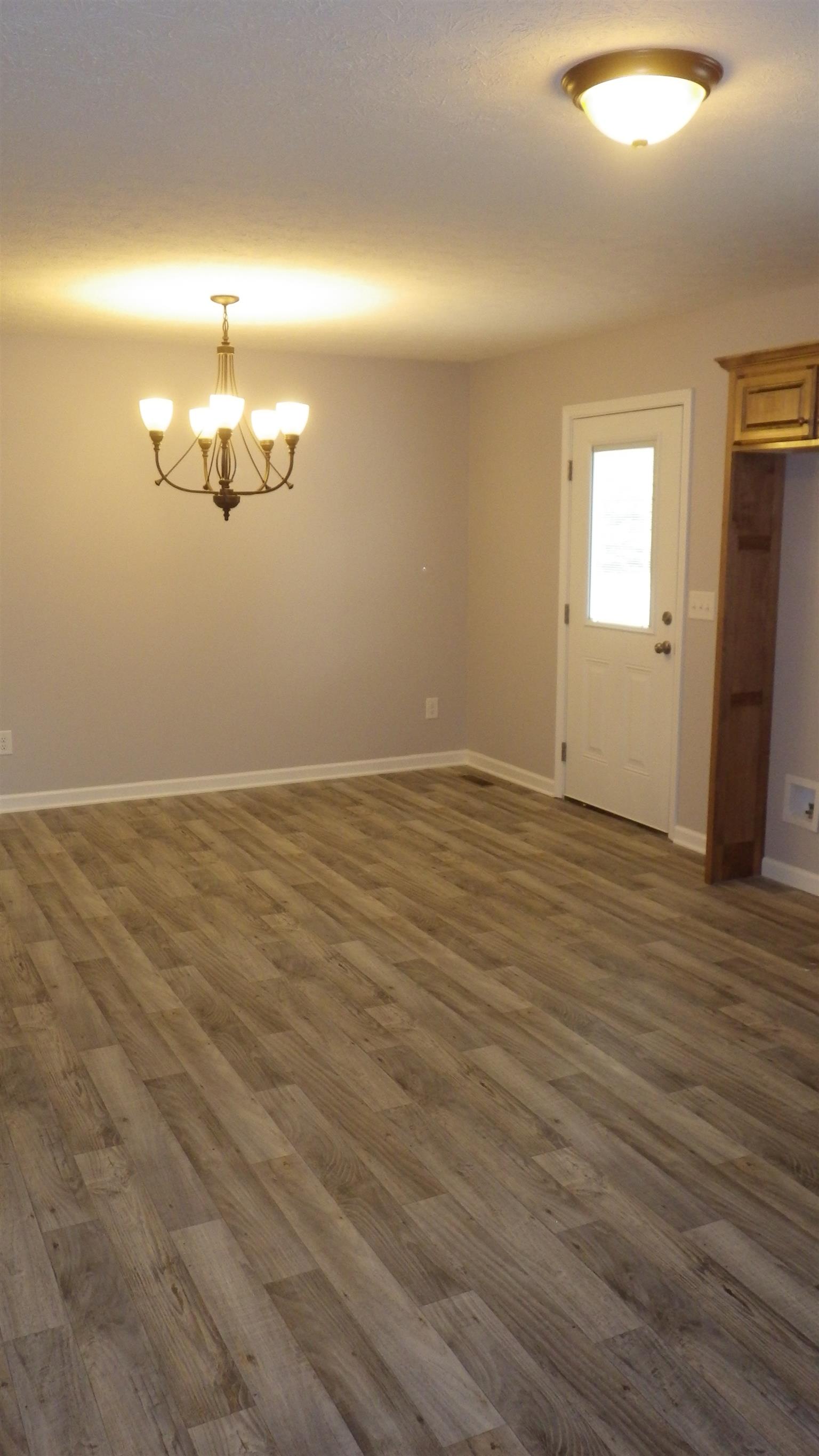1211 East Ab Wade Road Portland, TN 37148 - Photo 20 of 30 an empty room with wooden floor and windows