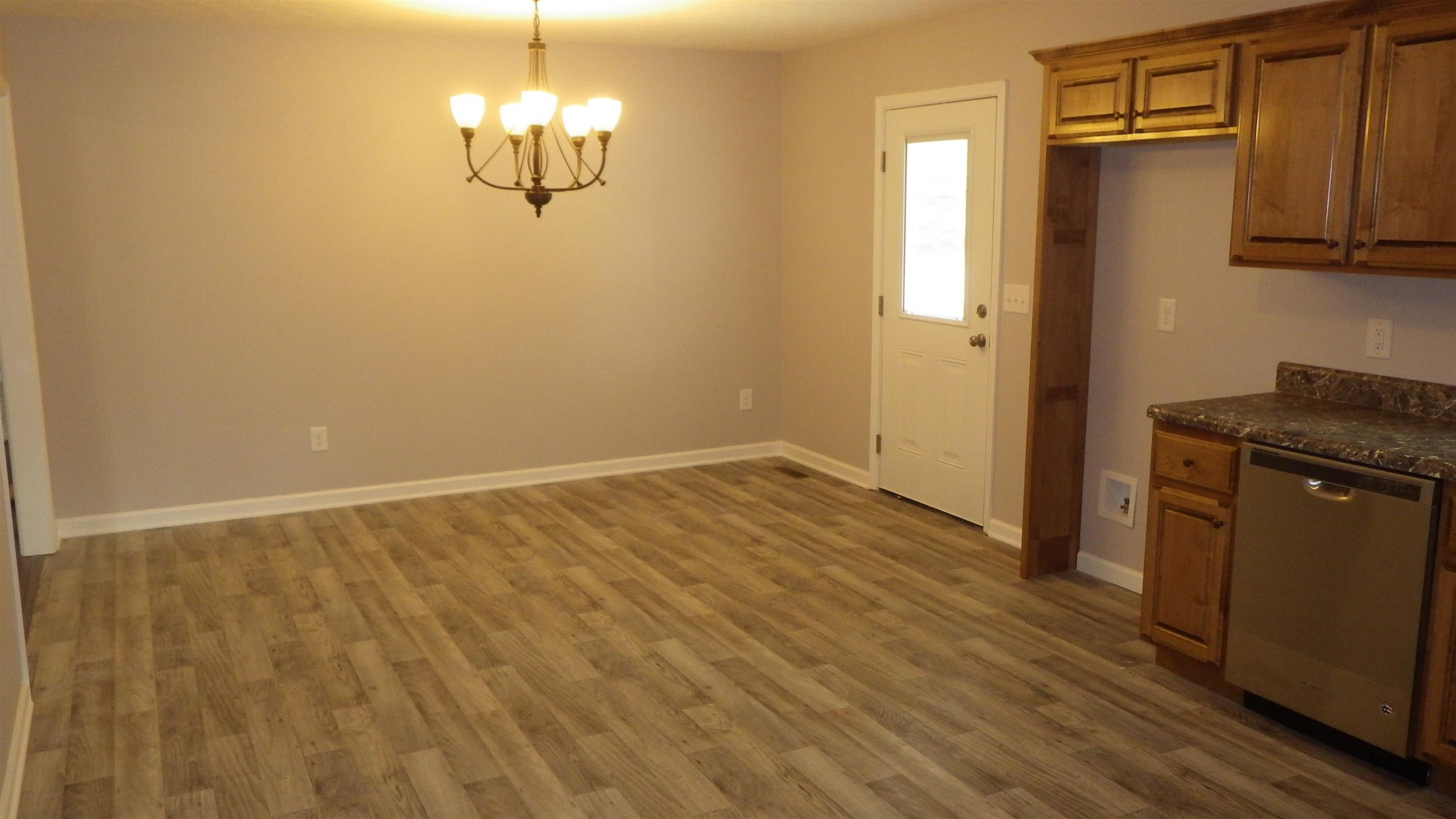 1211 East Ab Wade Road Portland, TN 37148 - Photo 23 of 30 a view of a kitchen with wooden floor and a window