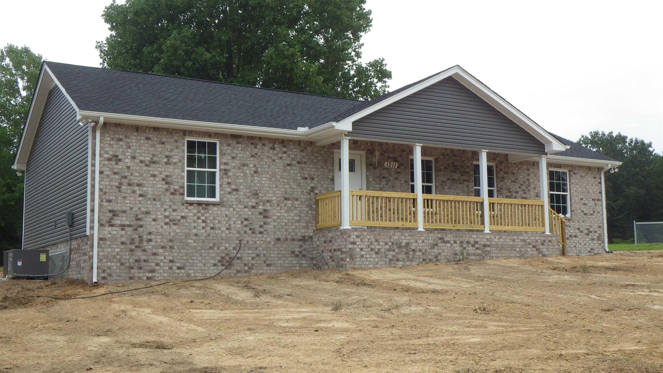 1211 East Ab Wade Road Portland, TN 37148 - Photo 4 of 30 a front view of a house with a garden