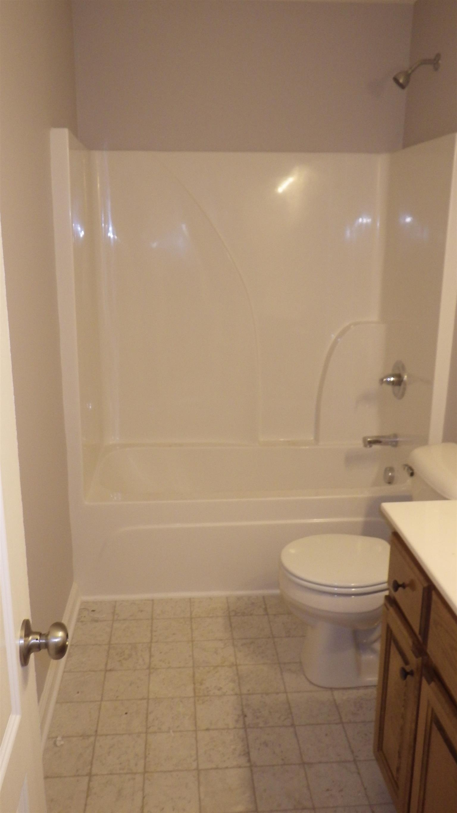 1211 East Ab Wade Road Portland, TN 37148 - Photo 9 of 30 a bathroom with a toilet a sink and a shower