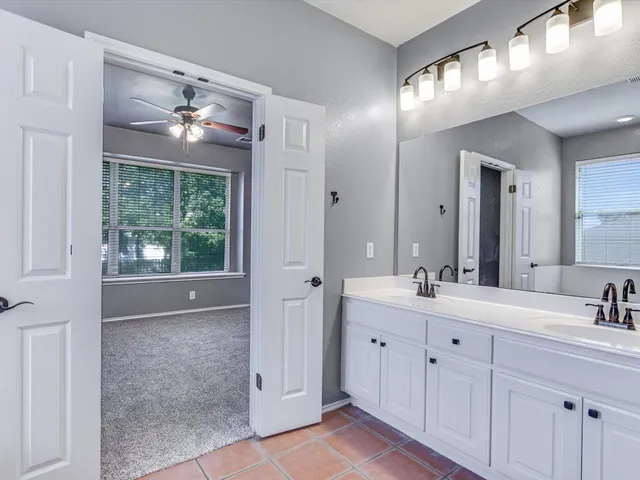 a bathroom with a double vanity sink and a mirror