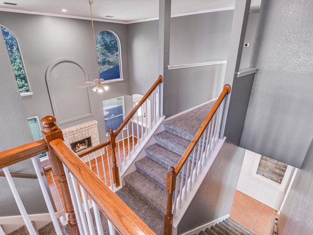 19910 Kennemer Drive Pflugerville, TX 78660 - Photo 8 of 21 a view of staircase with lots of frames on wall and stairs