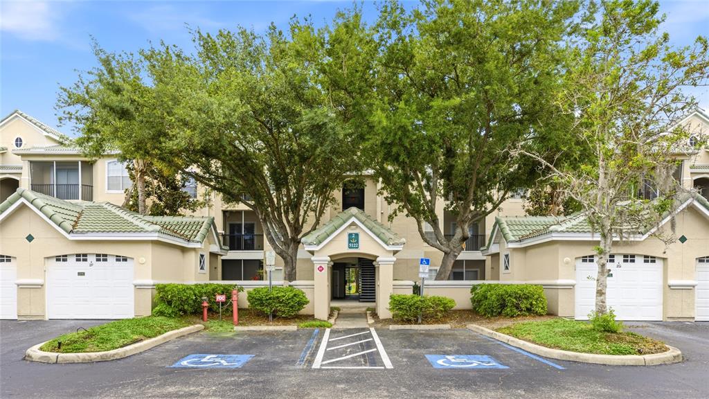 5122 Northridge Road, Unit 307 Sarasota, FL 34238 - Photo 1 of 51 front view of a house with a yard