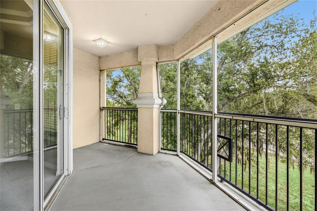 5122 Northridge Road, Unit 307 Sarasota, FL 34238 - Photo 12 of 51 a view of a room with balcony and floor to ceiling windows