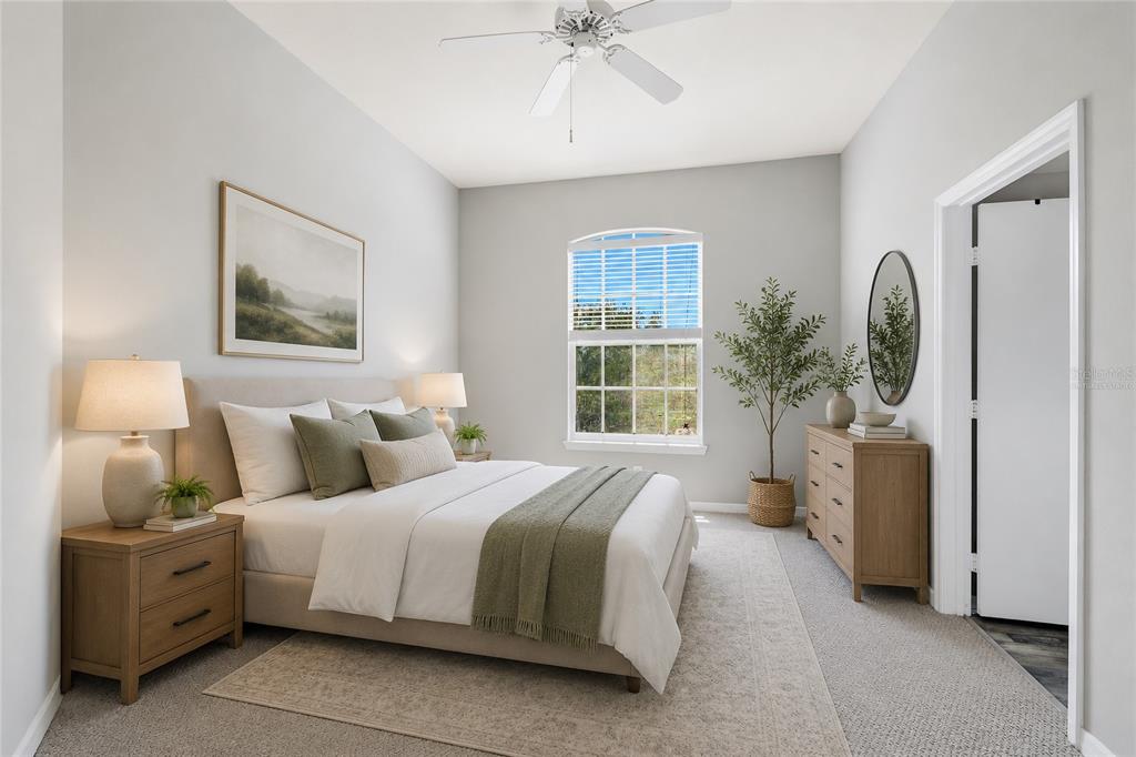 5122 Northridge Road, Unit 307 Sarasota, FL 34238 - Photo 15 of 51 a spacious bedroom with a bed a chandelier and mirror
