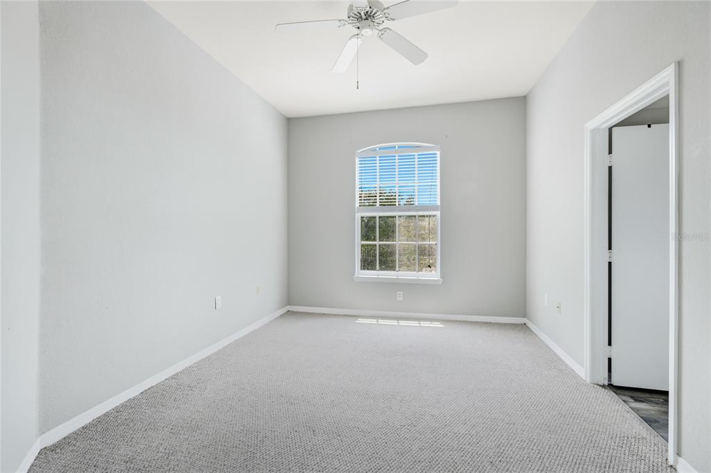 5122 Northridge Road, Unit 307 Sarasota, FL 34238 - Photo 16 of 51 an empty room with a ceiling fan and a window