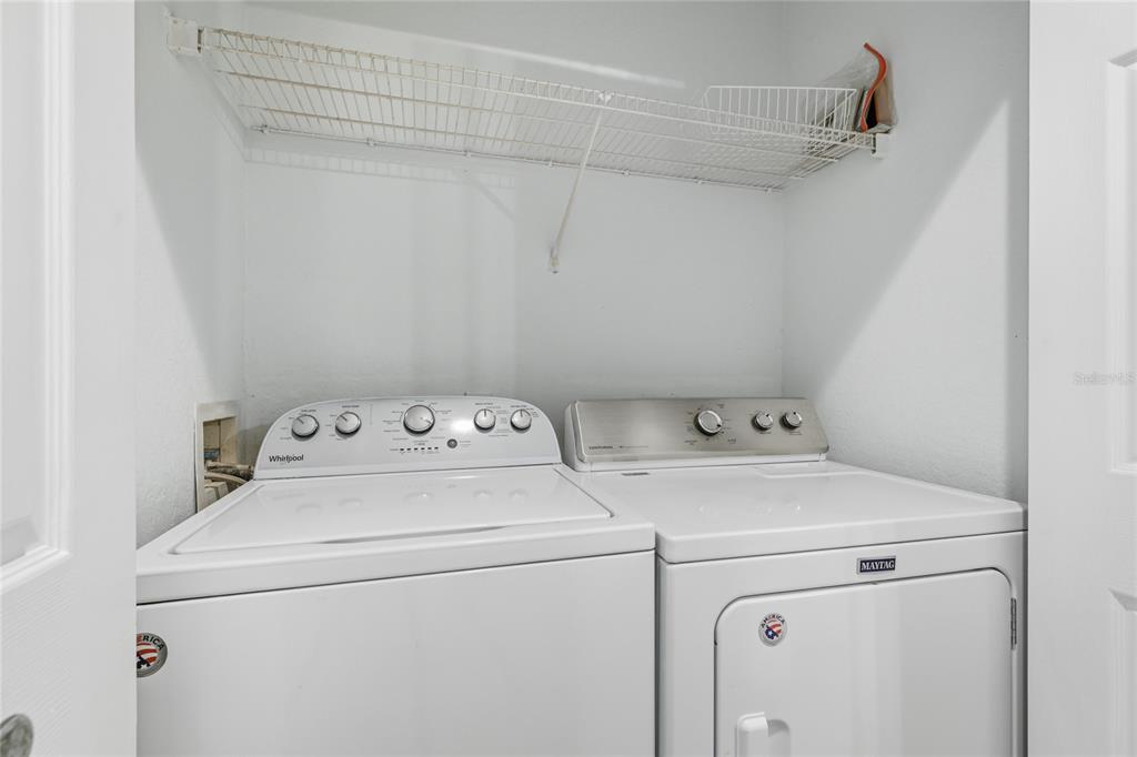 5122 Northridge Road, Unit 307 Sarasota, FL 34238 - Photo 26 of 51 a view of storage and utility room with washer and dryer
