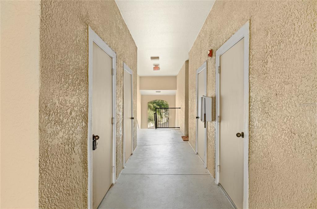 5122 Northridge Road, Unit 307 Sarasota, FL 34238 - Photo 3 of 51 a view of a hallway with wooden shelves