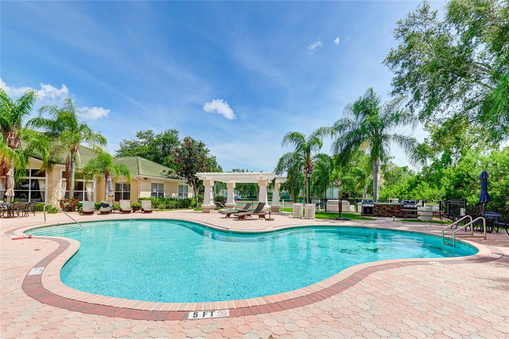 5122 Northridge Road, Unit 307 Sarasota, FL 34238 - Photo 34 of 51 a view of a house with swimming pool and sitting area