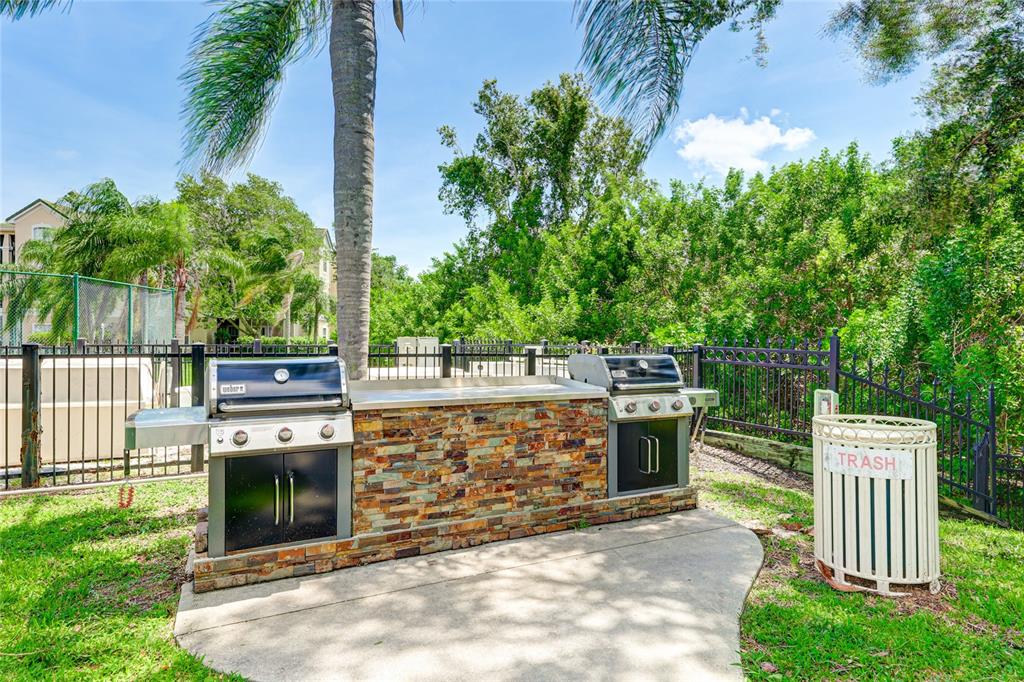 5122 Northridge Road, Unit 307 Sarasota, FL 34238 - Photo 35 of 51 a view of a dinning table and chairs in the garden