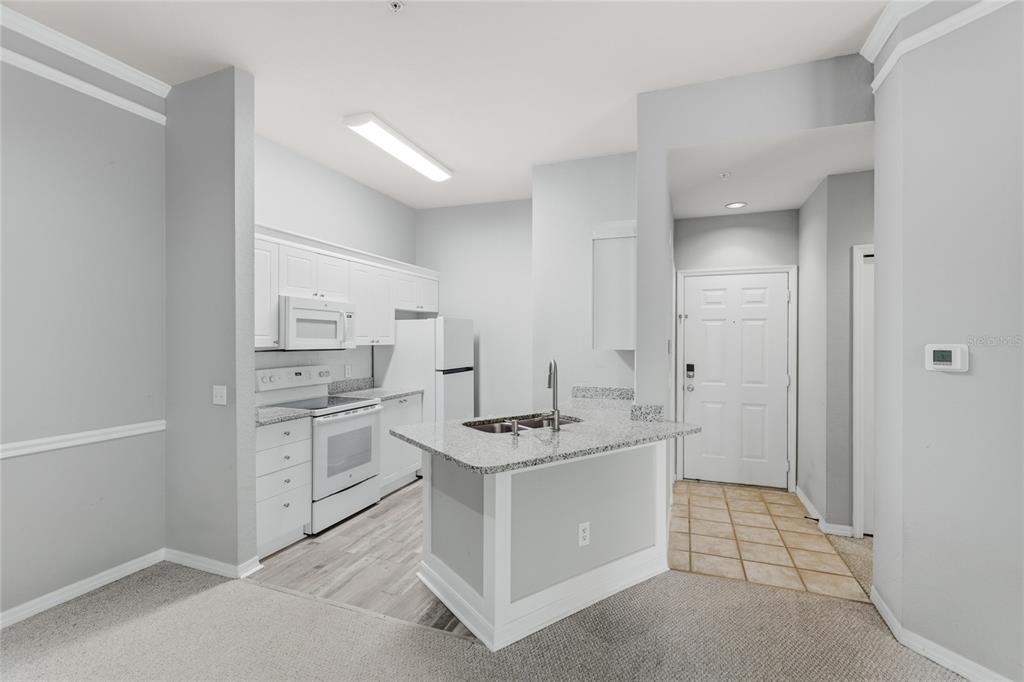 5122 Northridge Road, Unit 307 Sarasota, FL 34238 - Photo 8 of 51 a spacious bathroom with a granite countertop sink a mirror and a