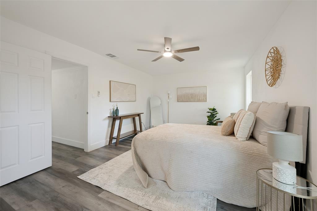 3004 Raintree Court Bedford, TX 76021 - Photo 17 of 25 Wood-finish flooring, white walls, and a ceiling fan with integrated lighting
