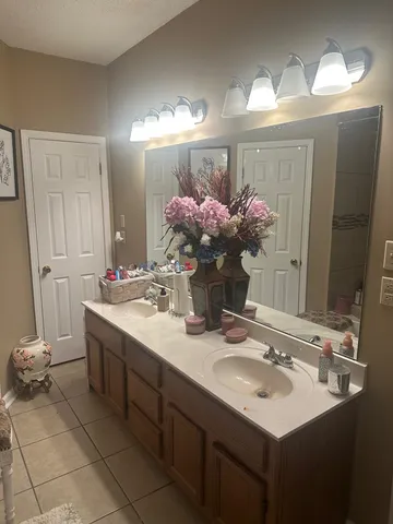 a bathroom with a sink vanity and a mirror