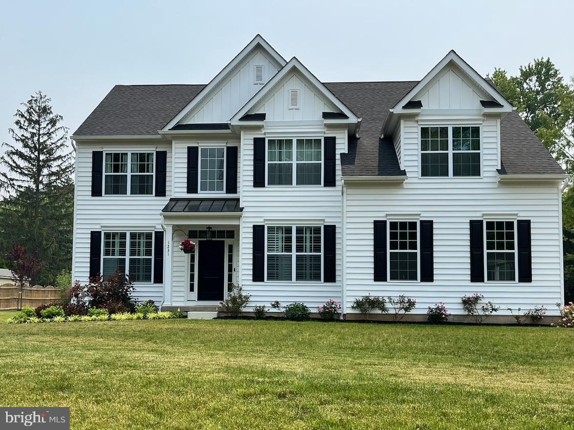 a front view of a house with a yard and swimming pool