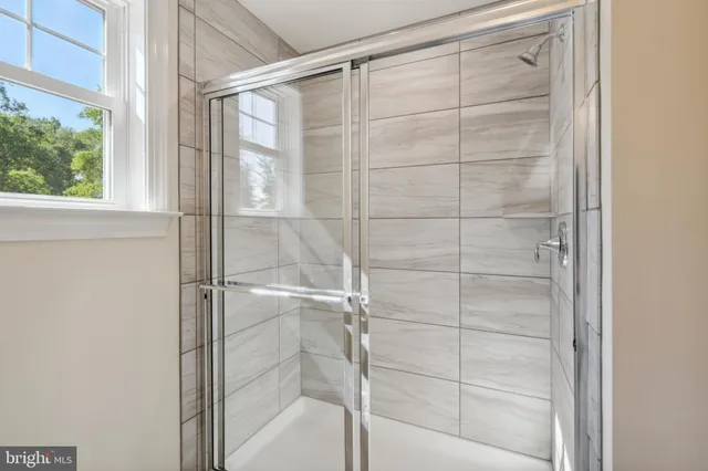 a bathroom with a glass shower door