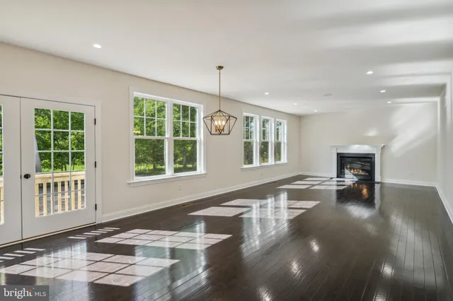 a view of a livingroom with furniture window and wooden floor