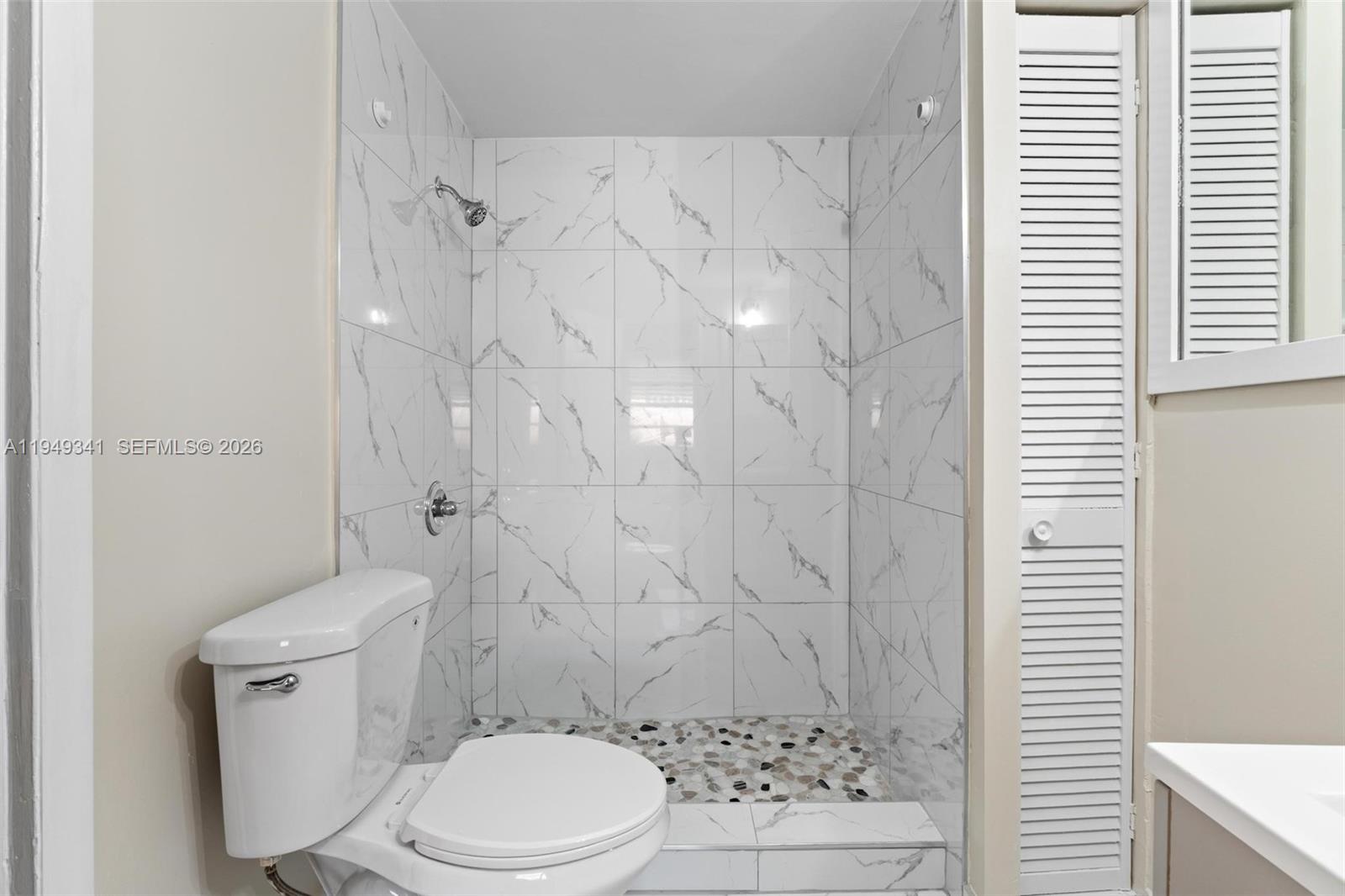 3507 Southwest 25th Terrace Miami, FL 33133 - Photo 13 of 32 a white toilet sitting next to a bathroom sink