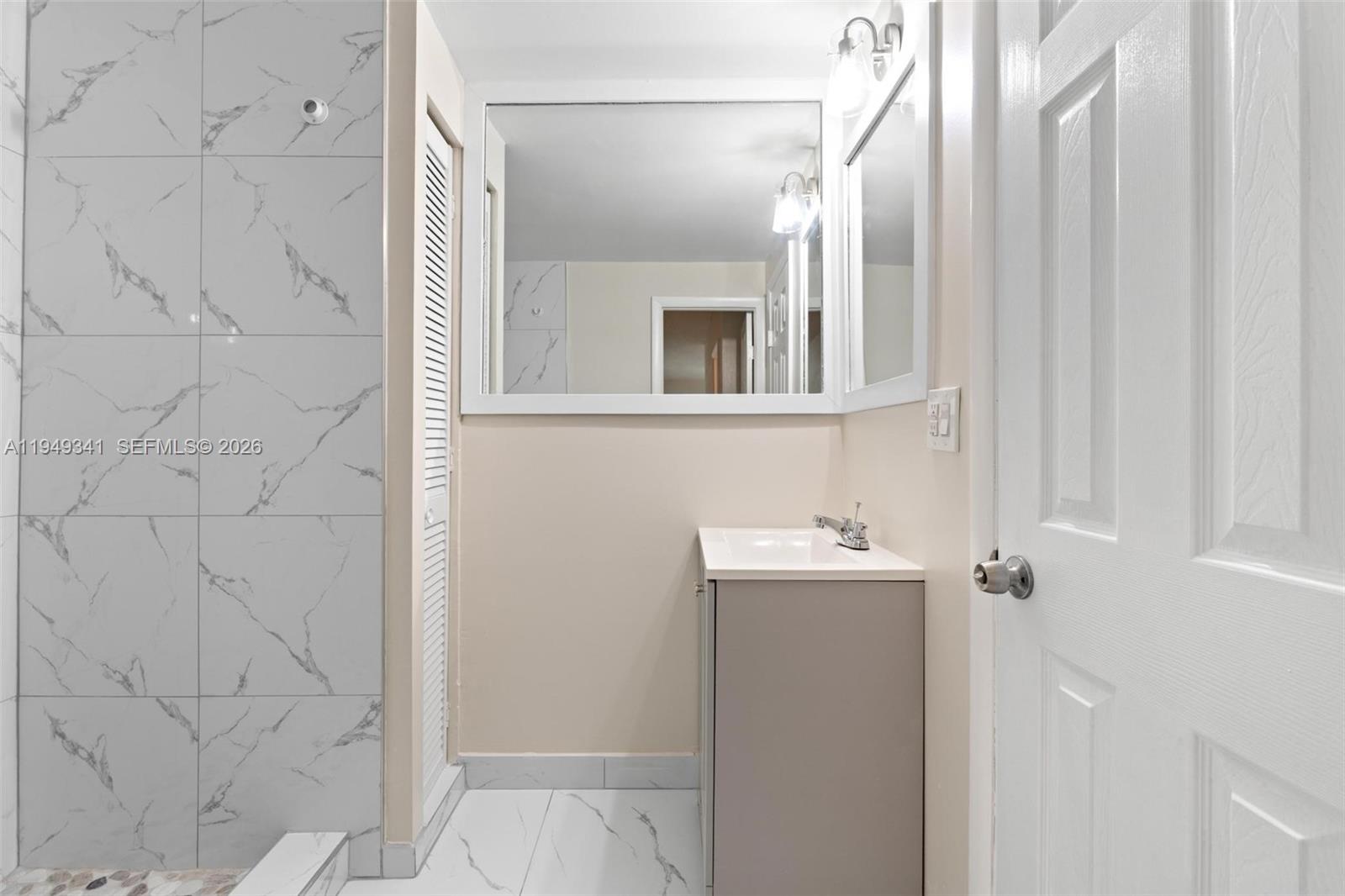 3507 Southwest 25th Terrace Miami, FL 33133 - Photo 14 of 32 a bathroom with a sink and mirror