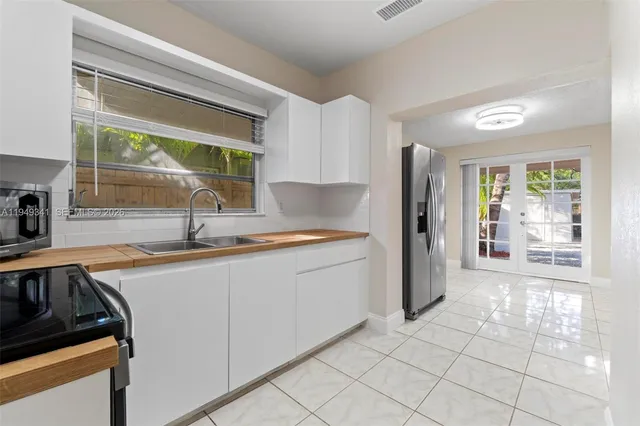 a kitchen with a sink and a refrigerator