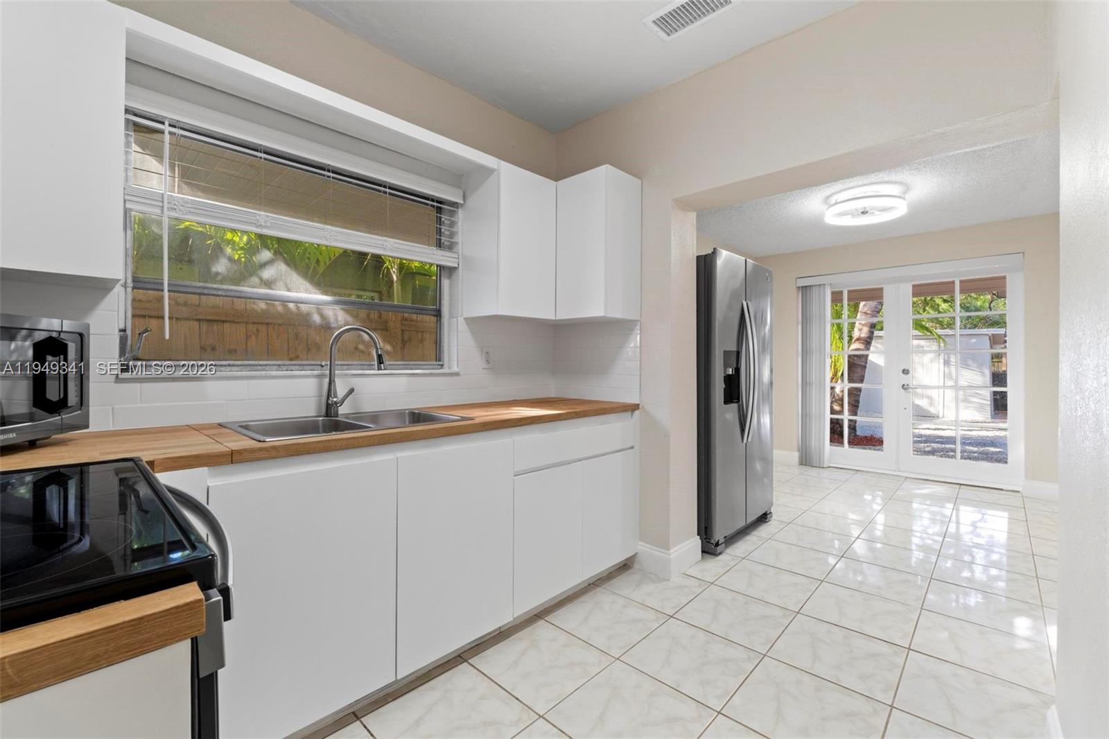 3507 Southwest 25th Terrace Miami, FL 33133 - Photo 9 of 32 a kitchen with a sink and a refrigerator