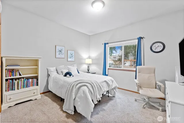 a bathroom with a granite countertop sink a toilet and a mirror