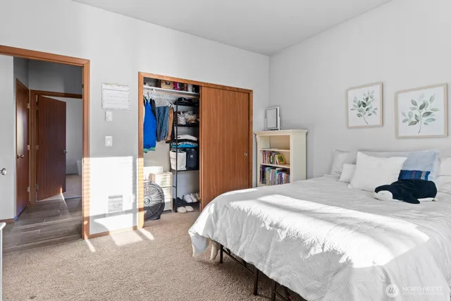 a bedroom with a bed and a flat screen tv