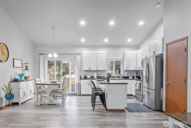 a kitchen with stainless steel appliances kitchen island granite countertop a sink and cabinets