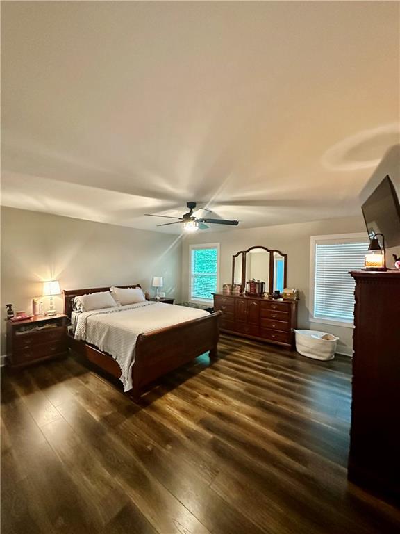 815 Poplar Street Monticello, GA 31064 - Photo 27 of 33 a spacious bedroom with a bed and wooden floor