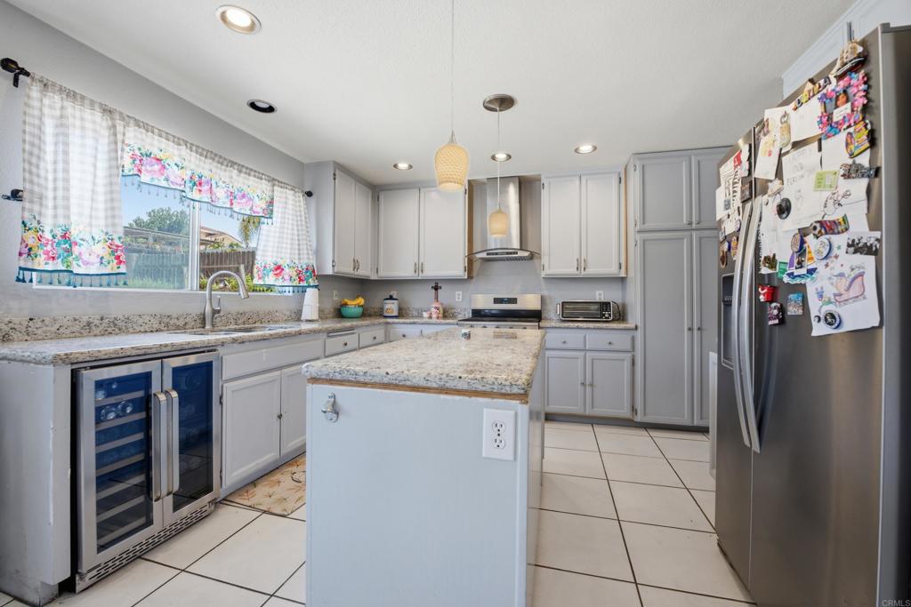 2077 Westwood Road Vista, CA 92083 - Photo 14 of 37 a kitchen with stainless steel appliances granite countertop a refrigerator sink and stove