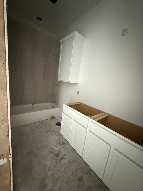 127 Riparian Elms Road Bertram, TX 78605 - Photo 14 of 22 A new construction bathroom awaits customization with a bathtub, ready for finishing touches.
