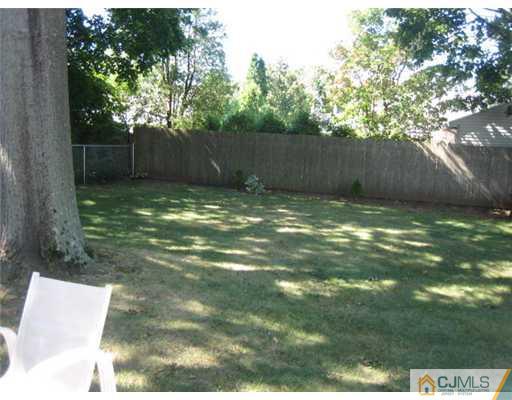 16 Altamont Road Edison, NJ 08817 - Photo 13 of 16 a view of a yard with a large trees and wooden fence