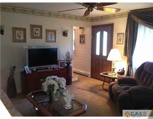 16 Altamont Road Edison, NJ 08817 - Photo 6 of 16 a living room with furniture a chandelier and a flat screen tv