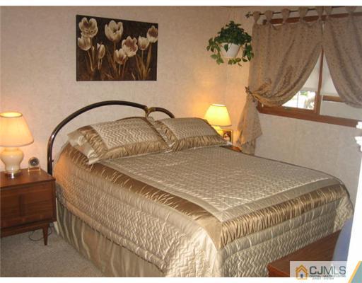 16 Altamont Road Edison, NJ 08817 - Photo 7 of 16 a bedroom with a bed and a painting on the wall