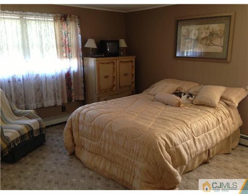 16 Altamont Road Edison, NJ 08817 - Photo 9 of 16 a bedroom with a bed and a painting on the wall
