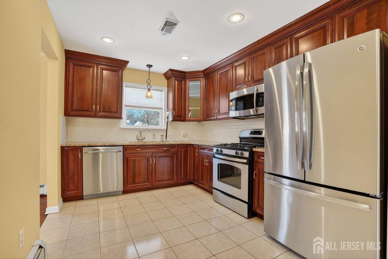 1 Wakefield Drive Edison, NJ 08820 - Photo 10 of 29 a kitchen with stainless steel appliances granite countertop a refrigerator stove a sink dishwasher and microwave